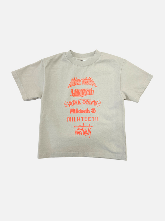 Image of Cement | Front view of kids short sleeved t-shirt on cement grey with neon orange text spelling Milk Teeth in various fonts.