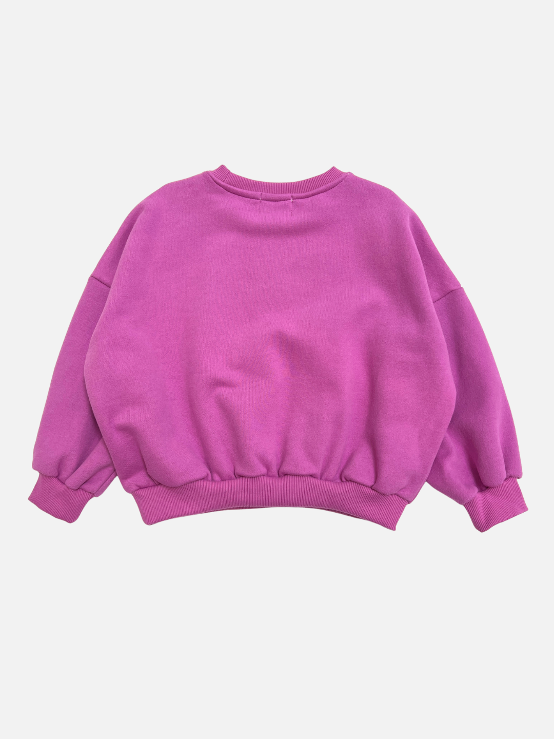 The REUNION SWEATSHIRT is a plain, long-sleeved crewneck in bright pink with ribbed cuffs and hem, shown laid flat on a white background.