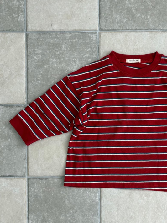 Second image of Red | The PEPPER LONGSLEEVE TEE in red, featuring white and navy stripes, is laid flat on a white background; this oversized cotton tee reflects the effortless style of popular Korean kids’ brands.