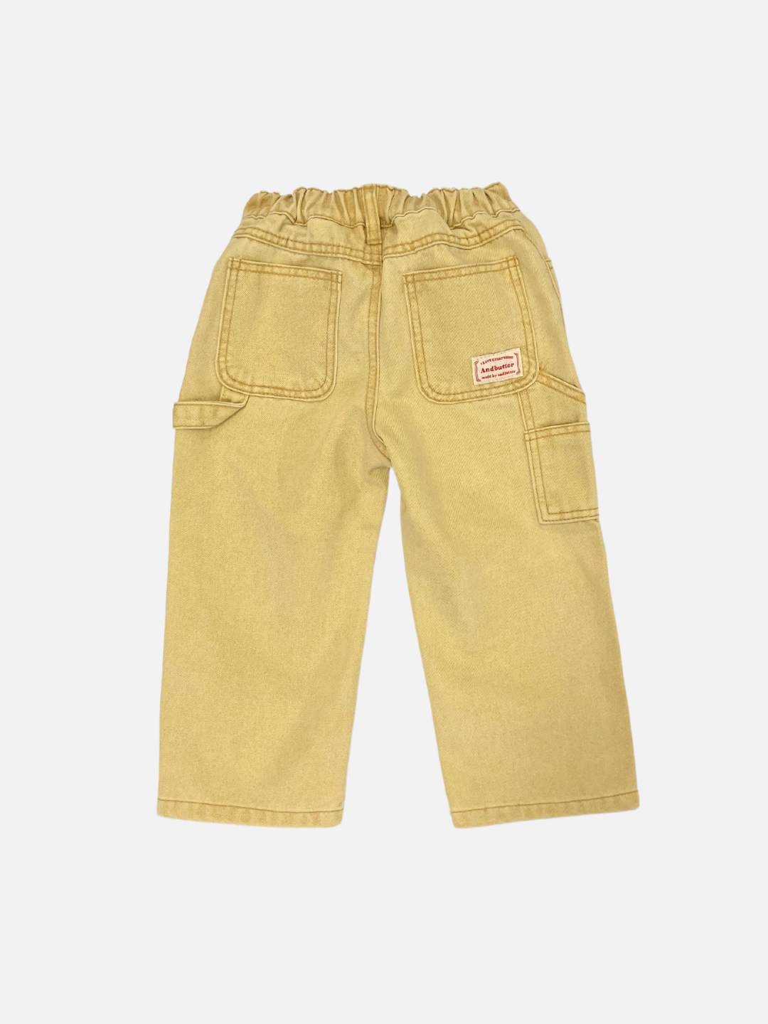 Ochre | Back view of children's "PIGMENT CARPENTER JEANS" in beige with an elastic waistband, large patch pockets, and a small red label on the right pocket.