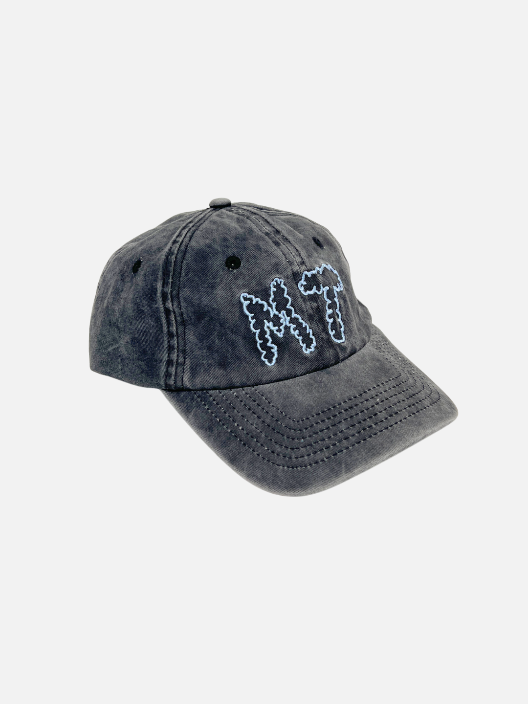 The MT DAD CAP is a black washed cotton canvas baseball cap featuring "MT" (Milk Teeth) embroidered in blue on the front, shown against a plain white background.