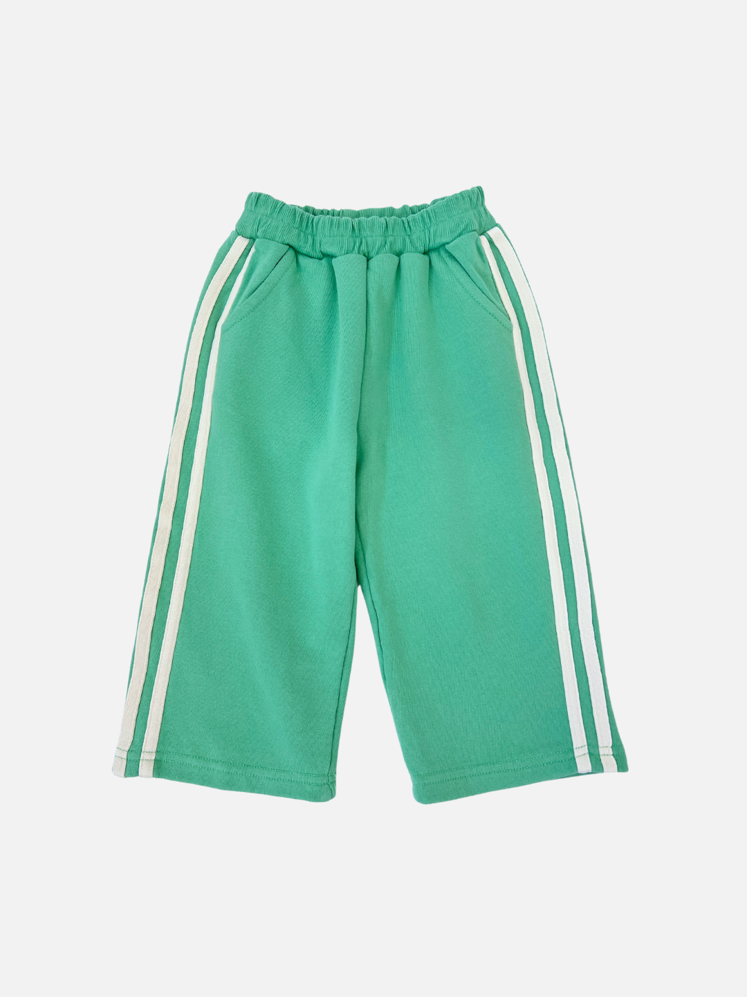 The Minty Stripe Track Pants from Bon Bon Butik are green, made of cotton loop-back terry, and feature an elastic waistband with white side stripes on both legs.