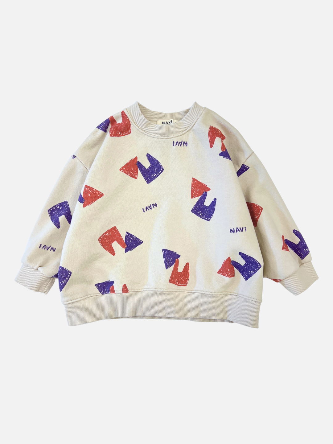 Front view of kids beige crewneck sweatshirt with an all over pattern of red and purple shapes and the brand name Navi.