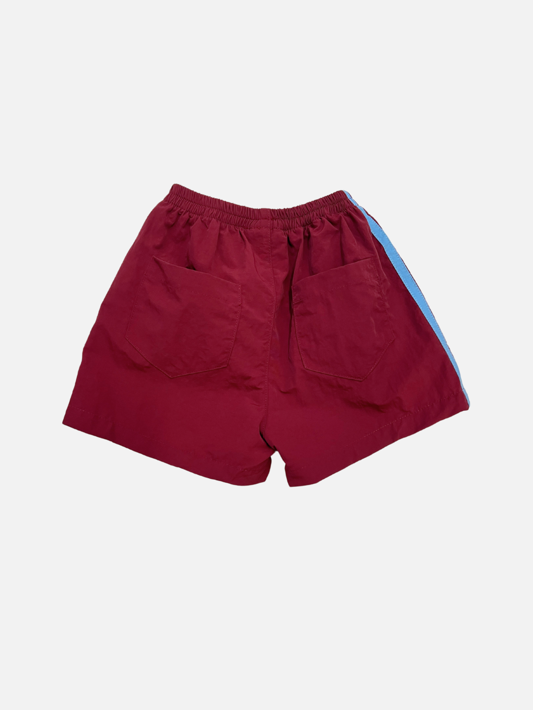 SPRINTER SHORTS: Maroon performance track shorts with two back pockets, elasticated waist, and a blue left-side stripe, shown on a white background.
