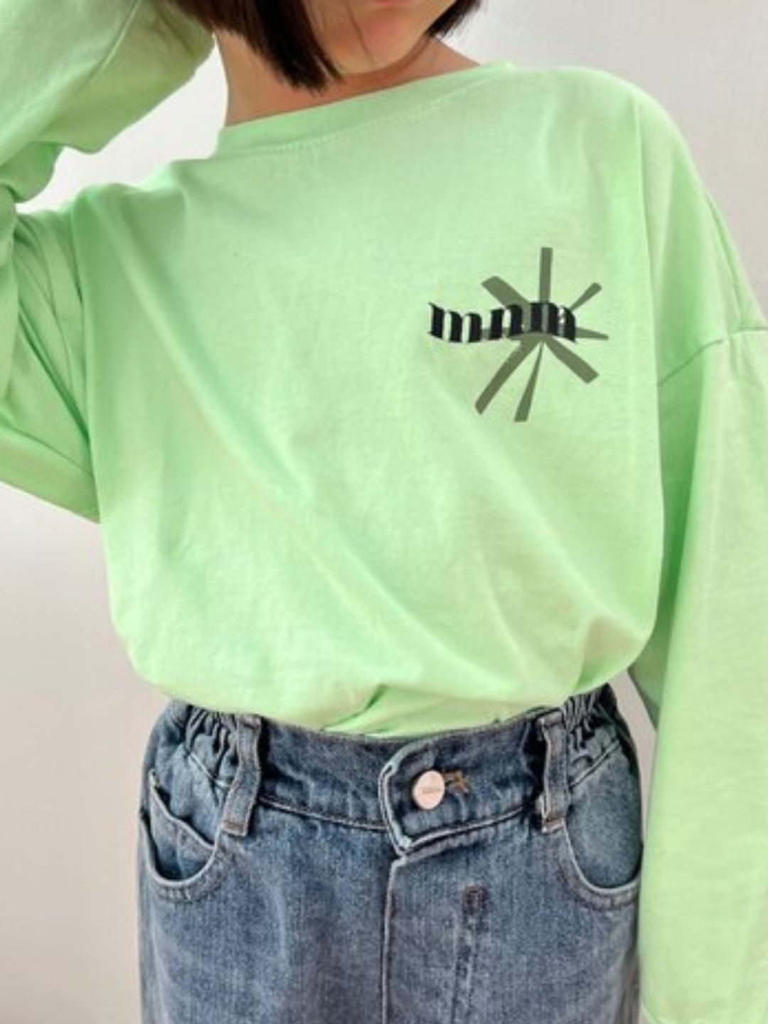 Child is wearing green Minimal Longsleeve Tee with blue jeans
