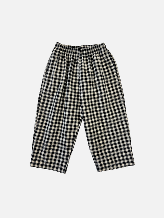 Image of Front view of kids black and off-white gingham check pants.