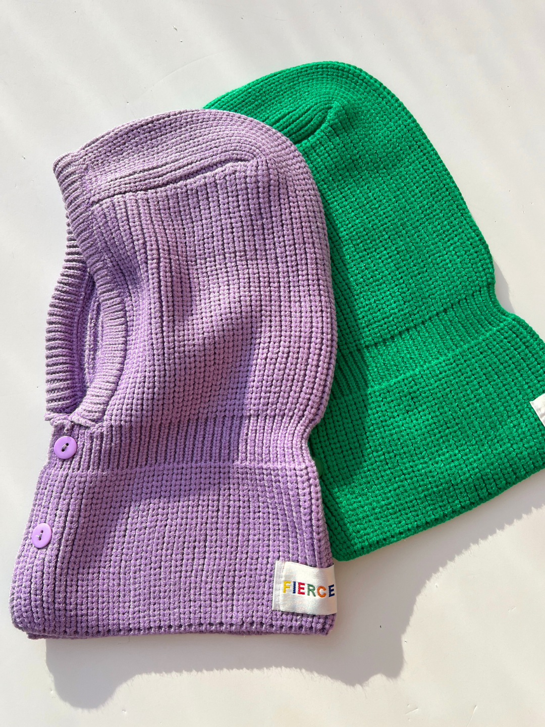 Purple | Purple and Green Balaclava laid flat on white background.