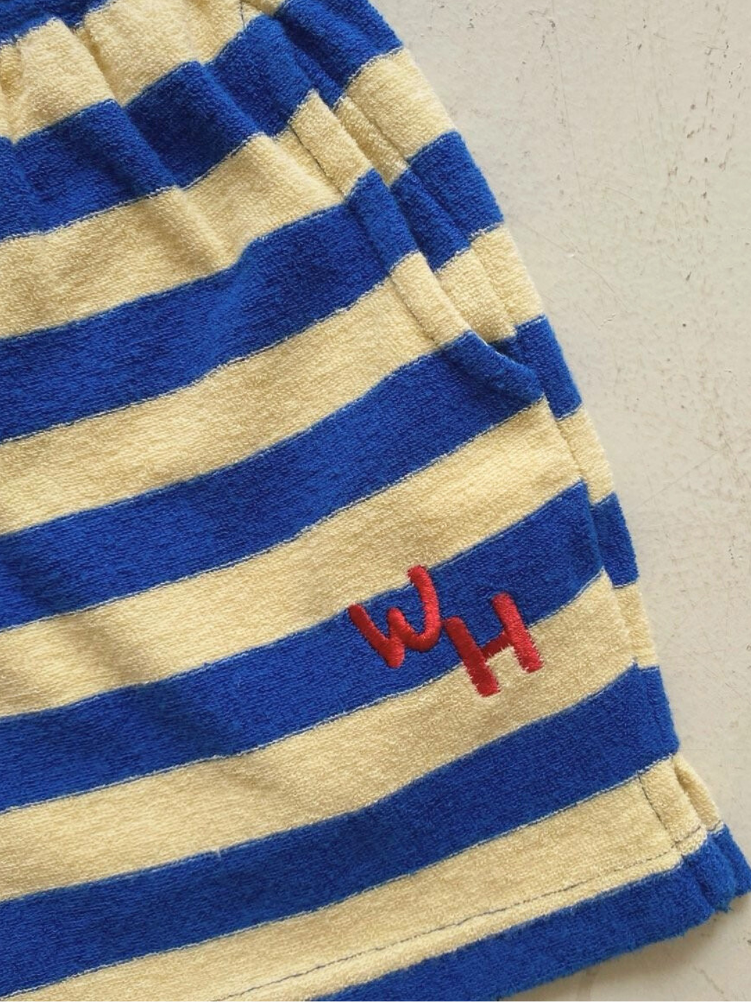 Red WH embroidered logo on blue/yellow riviera shorts