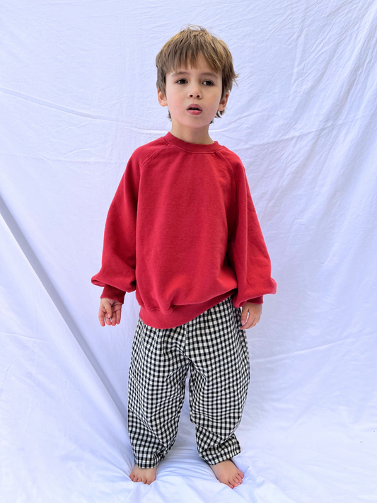 Second image of Front view of kids black and off-white gingham check pants.