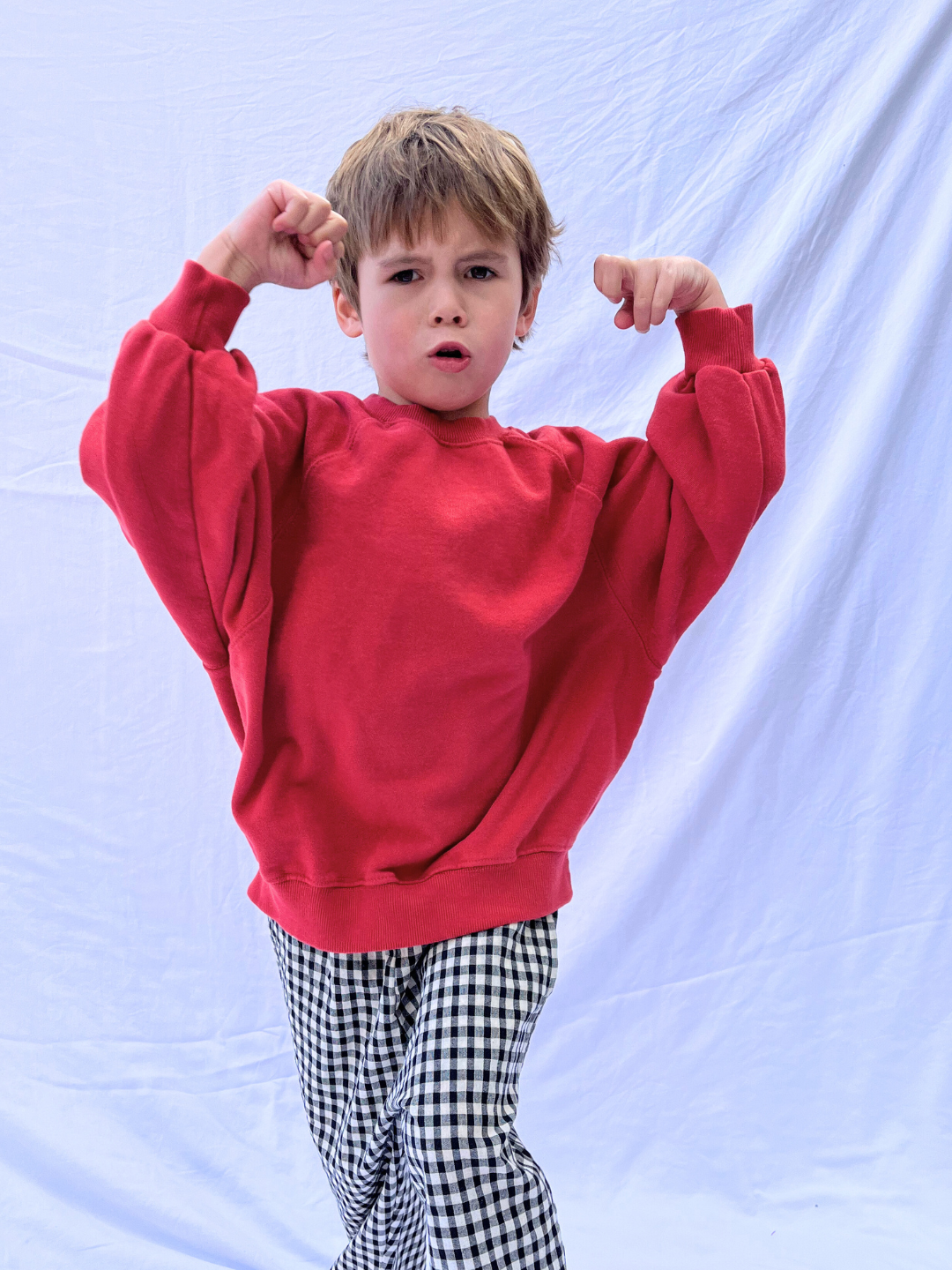 Red | The PLAYDATE SWEATSHIRT, a red oversized garment-dyed cotton terry design from a Korean kids brand, features long sleeves and ribbed cuffs.