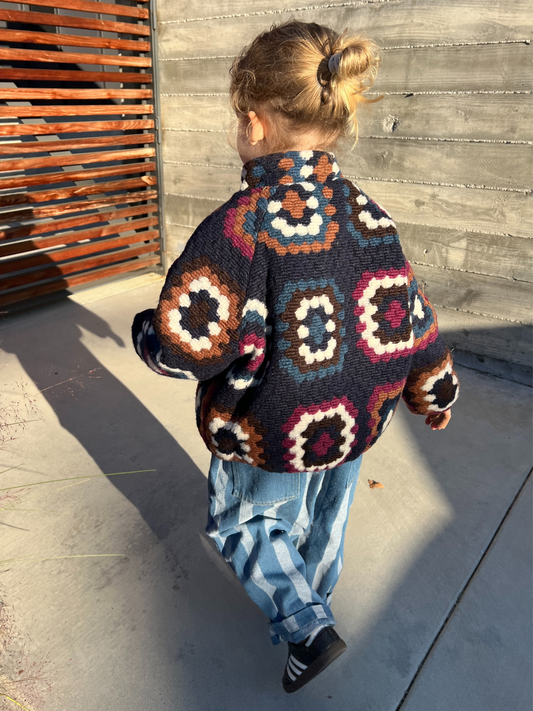 Second image of Navy | Front view of the vibrant navy fleecy TUFTED WOOL JACKET with a geometric pattern in shades of blue, brown, red, and white, featuring a front zipper and a cozy funnel-neck style.