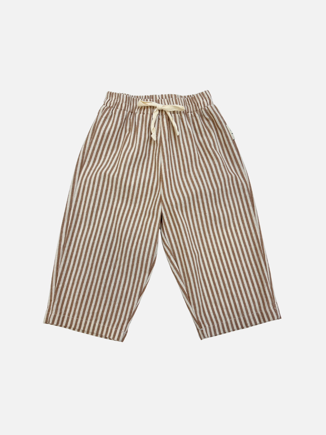 Tan | COCO STRIPE BABY PANTS in tan feature wide legs, brown and beige vertical stripes, a comfy elastic waistband with drawstring, and are shown on a plain white background.