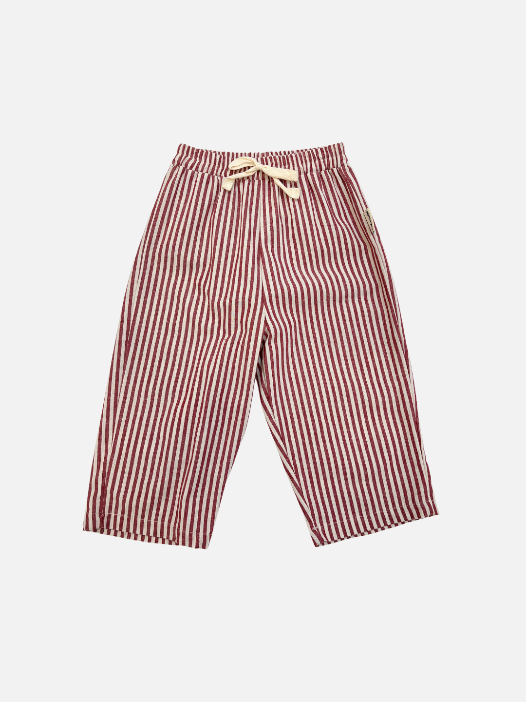 COCO STRIPE BABY PANTS in red, featuring vertical stripes, an elastic waistband, and a cream drawstring, displayed flat on a white background.