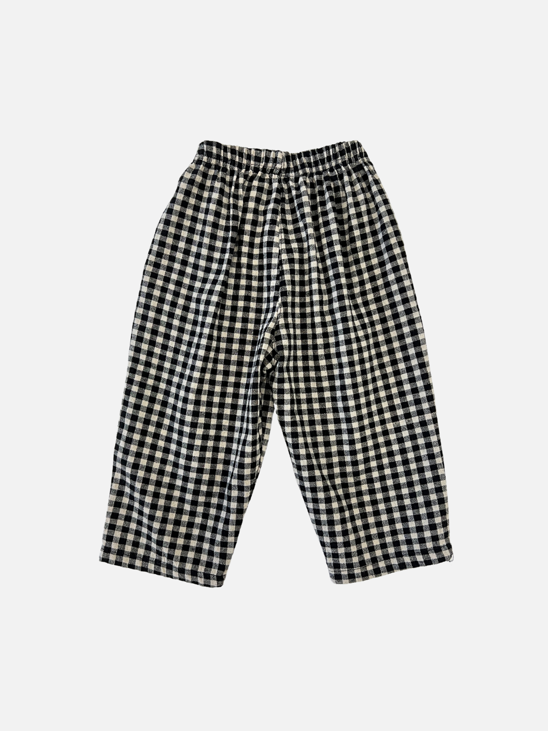 Back view of kids black and off-white gingham check pants.