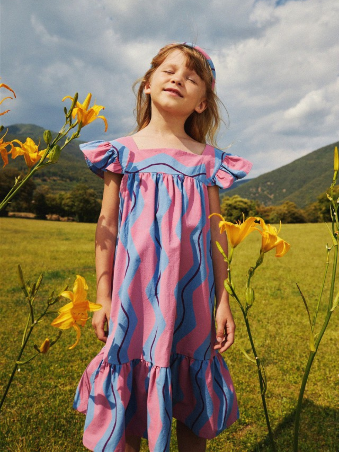 Child wearing Wave Stripe Dress outdoors.