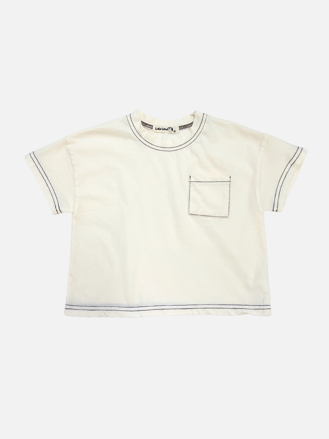 Front view of the kids' stitch pocket tee in Ivory feturing contrast black stitch and a small pocket on the right side