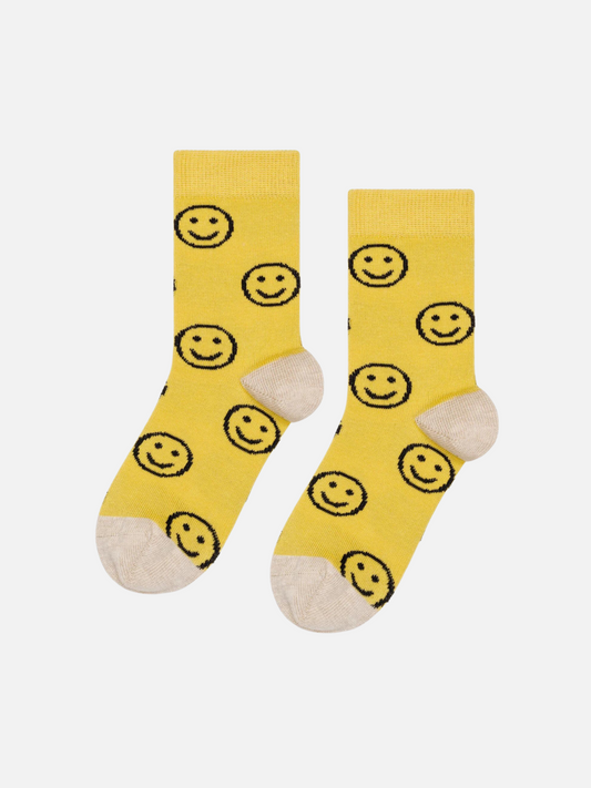 Image of A pair of kids' ankle socks in yellow with black smileys and cream toes and heels