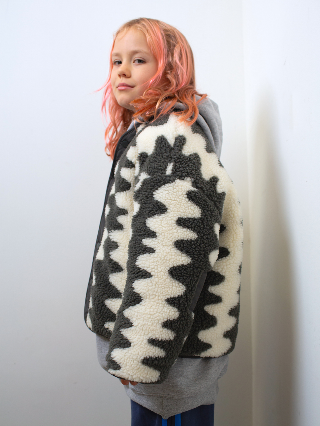 Charcoal | Person wearing a patterned sweater with a white background