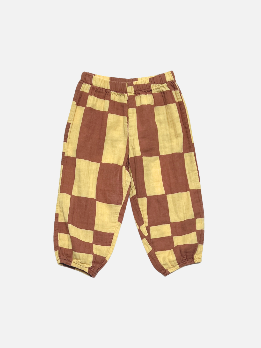 Yellow Checkers | The MUSLIN PULL ON PANT features a loose fit, elastic waistband and cuffs, and a bold Yellow Checkers print on lightweight fabric, shown against a plain white background.