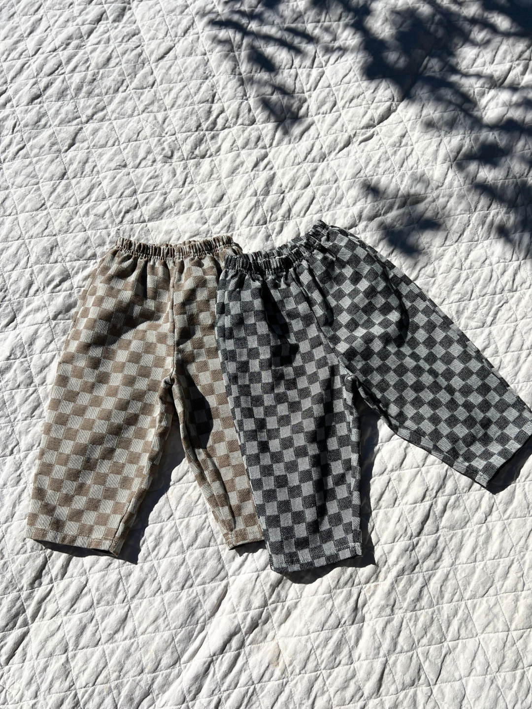 Charcoal | Charcoal & Stone Chess Club Pants laid on blanket