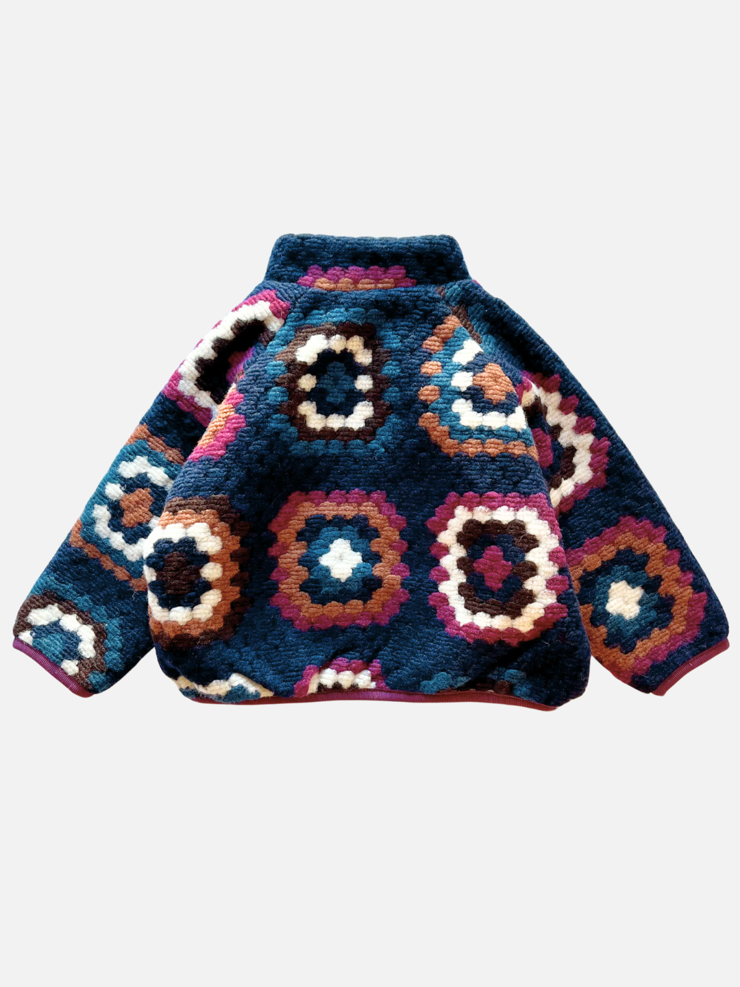 Navy | Back view of the TUFTED WOOL JACKET featuring a multicolored, fleecy design with a geometric hexagonal pattern in shades of navy blue, orange, purple, white, and brown. Its tufted wool-blend material and funnel-neck style offer both warmth and chic flair.