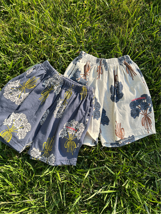 Second image of Navy | Front view of the kids' Bouquet Shorts. Navy cotton fabric with an all-over white roses bouquet print. 
