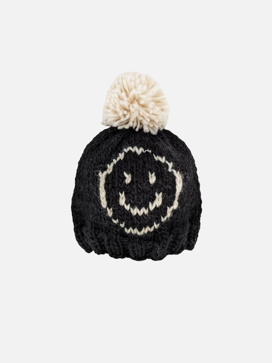 Baby and kids beanie hat in chunky knit black yarn with an off-white smiley face on the front and an off-white pom-pom on top.