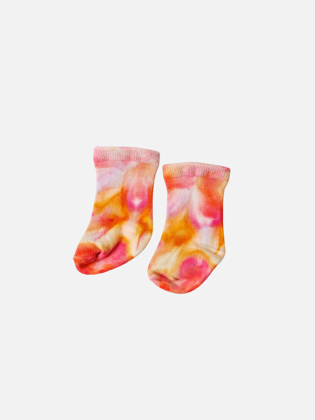 Pair of baby ankle socks in dappled shades of orange, pink and white
