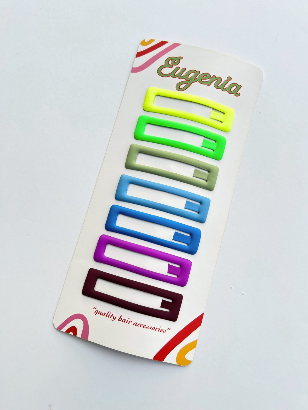 seven jumbo rainbow snap clips on it's Eugenia Clips packaging