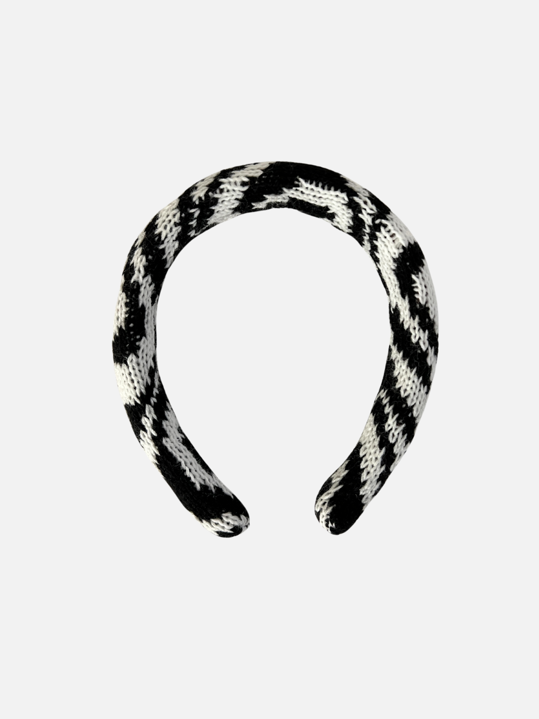 A kids' knitted headband in swirls of pale black and white