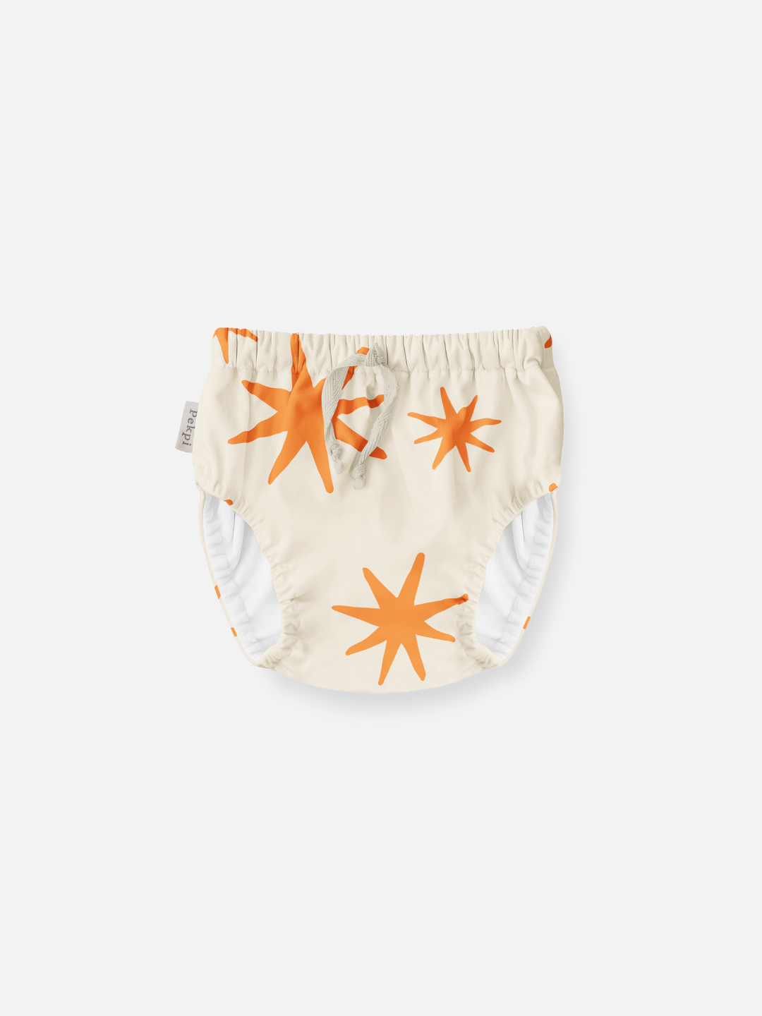 Capri | The front view of the swim diaper with an elastic waist with a tie and elastic leg holes. The diaper is a cream color with orange stars shapes all over.