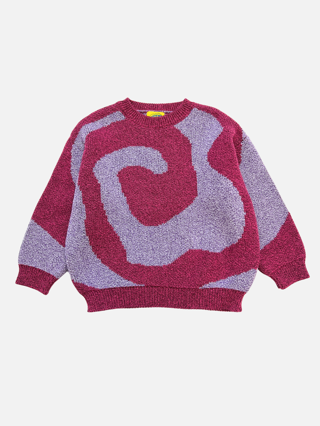 Pink/Purple | The SWIRL SWEATER is a long-sleeve sweater featuring a bold, abstract swirl pattern in pink and purple, shown on a plain white background.