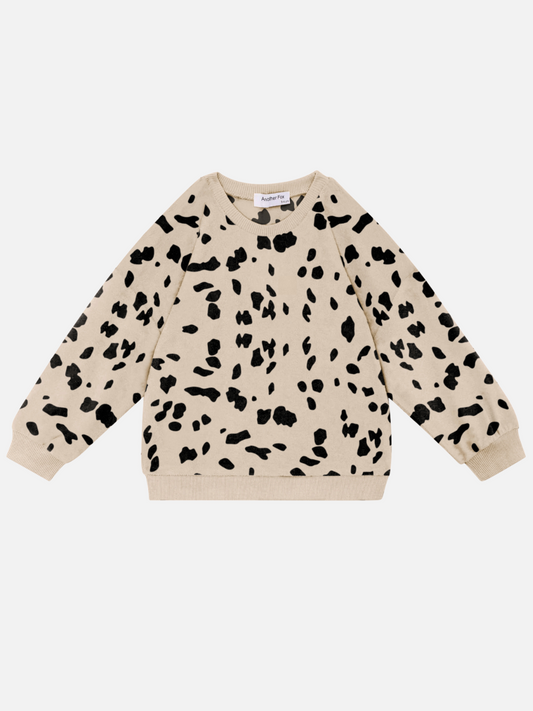 Image of The DALMATIAN TERRY SWEATSHIRT, a beige long-sleeve sweatshirt featuring a black abstract spotted pattern, is perfect for babies and laid flat on a white background. Check out this piece and other new arrivals when you shop all clothing.