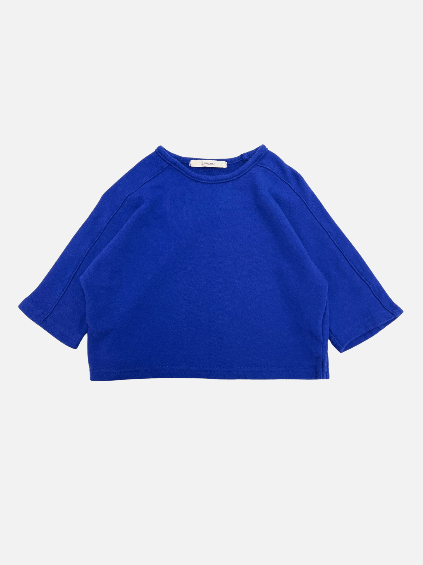 A cozy blue BABY BOATNECK LONGSLEEVE made from soft terry cotton, laid flat on a white background—perfect for fans of Korean baby brand essentials.