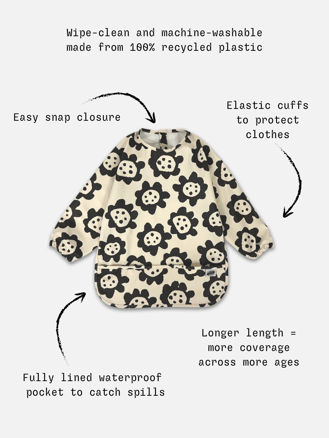 Detailed information of the long sleeve cream colored bib with black sunflowers and a front pocket.
