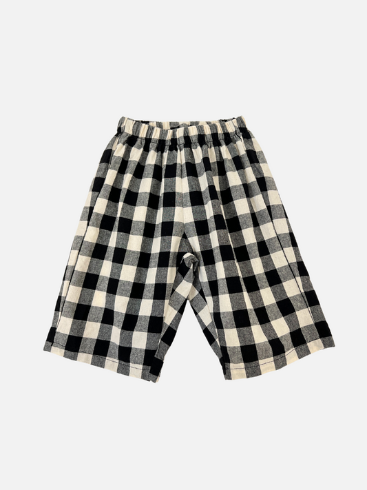 Image of BIG GINGHAM BABY PANTS, featuring a black and white checkered design with an elastic waistband, are essential merchandise displayed on a plain white background.