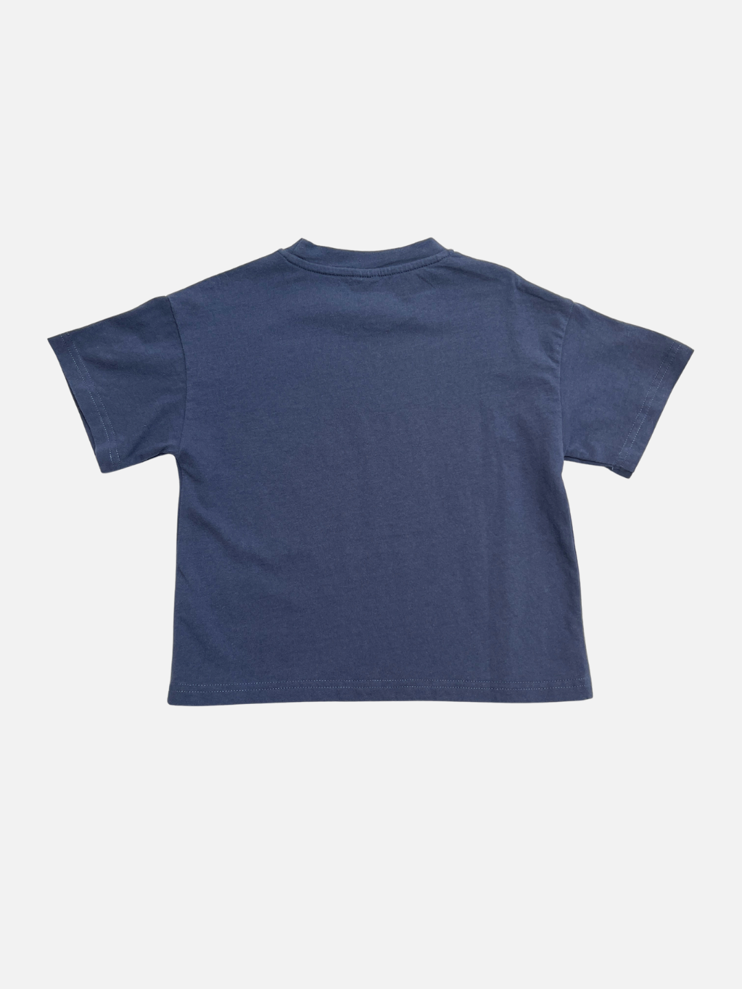 Blue | The SKYTIME TEE, an oversized boxy short-sleeve t-shirt in plain navy blue, is displayed laid flat with the back side facing up on a white background.