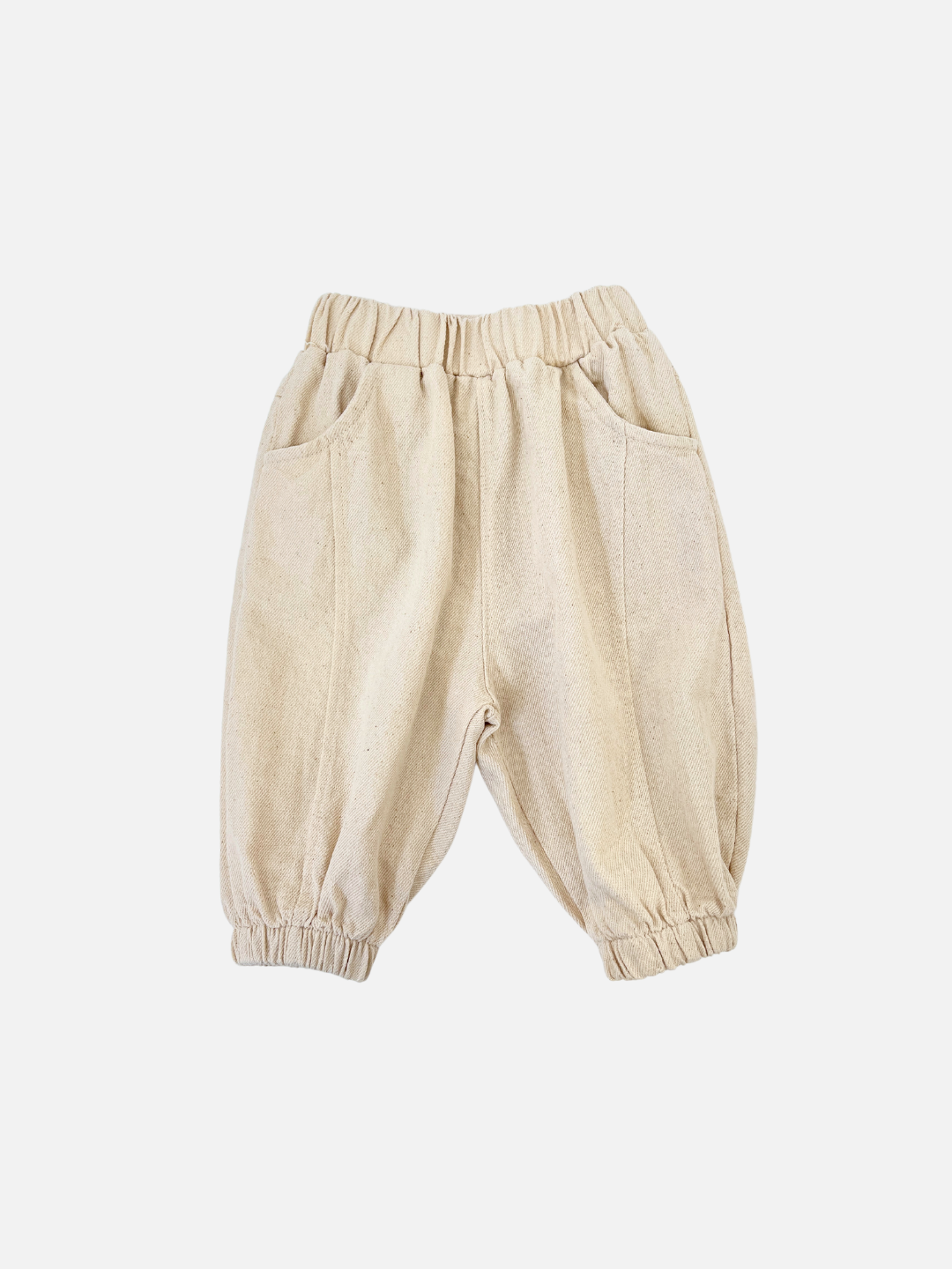 Ecru | Ecru BALLOON JEAN toddler pants feature an elastic waistband, cuffs, jogger-style fit, and two side pockets against a white background. Ideal for little ones who prioritize comfort and style, these Valu Baby pants are both practical and fashionable.