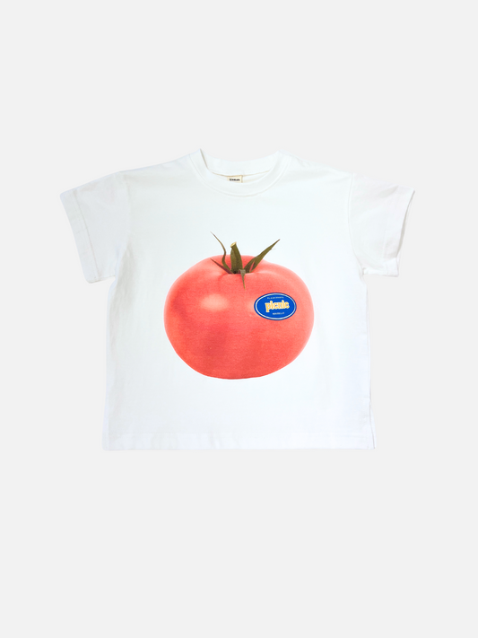 Image of Tomato | PICNIC TEE in Tomato: an oversized white cotton t-shirt from a Korean kids brand, featuring a bold tomato graphic with a blue sticker label on the front, shown against a plain background.