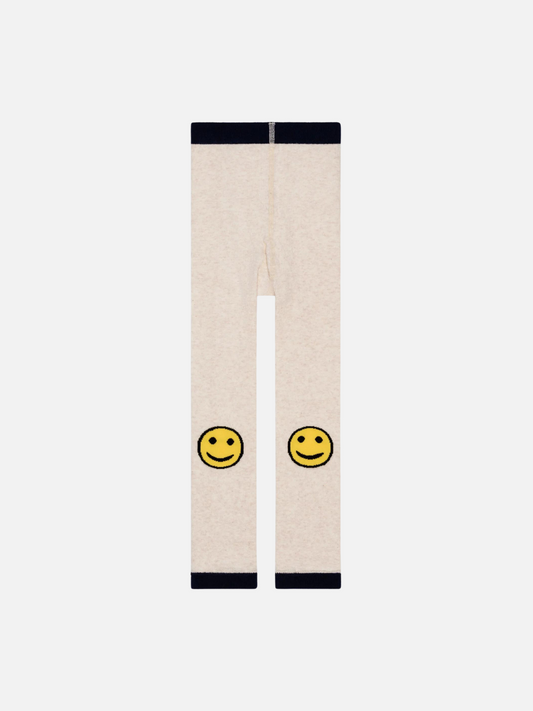 Image of A pair of kids' leggings in cream, with yellow smileys on the knees and black waistband and hems