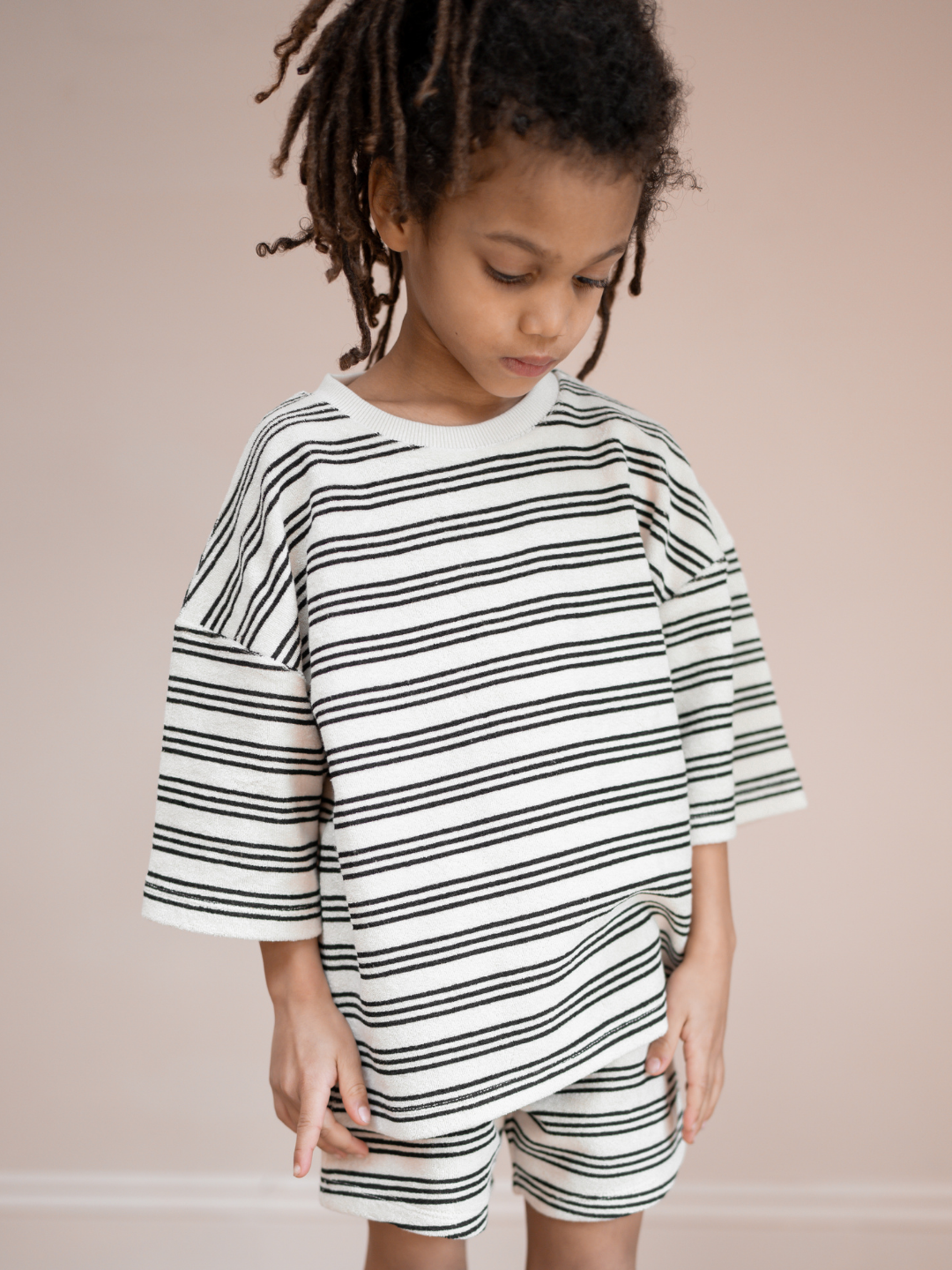 Stripe | A child is wearing matching set of stripe Terry towel shorts & tee