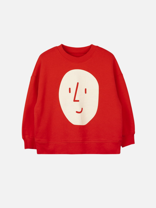 Image of Red | The POTATO SWEATSHIRT in red is an oversized OXOX CLUB piece made from organic cotton, featuring a minimalist white smiling face graphic on the front.