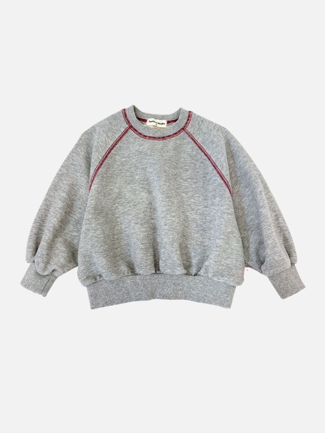 Grey | The VARSITY SWEATSHIRT by Cantucci Studios is a retro-inspired brushed cotton piece featuring a grey hue with red stitching, crew neck, and long sleeves, elegantly displayed on a white background.