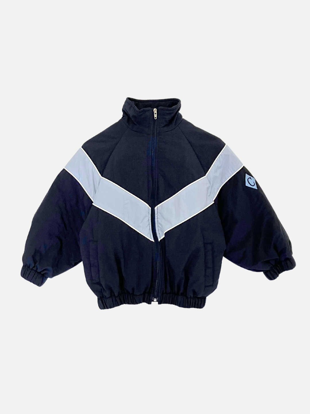 Navy | The WARM-UP JACKET in navy is a retro track jacket featuring a white horizontal stripe across the chest and arms, complemented by a high collar and elastic cuffs and hem. This lightweight layer adds stylish comfort to your wardrobe.