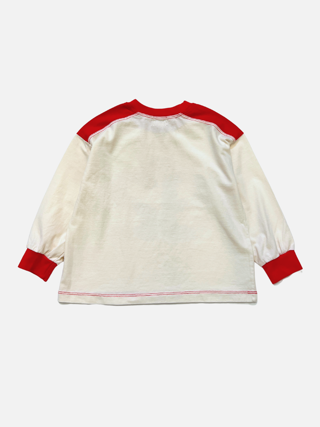 The MEMORY LANE LONGSLEEVE is a Korean kids' cotton top with an off-white body, red collar, shoulder panels, and cuffs for a vintage sports jersey vibe. Shown from the back on a plain white background.