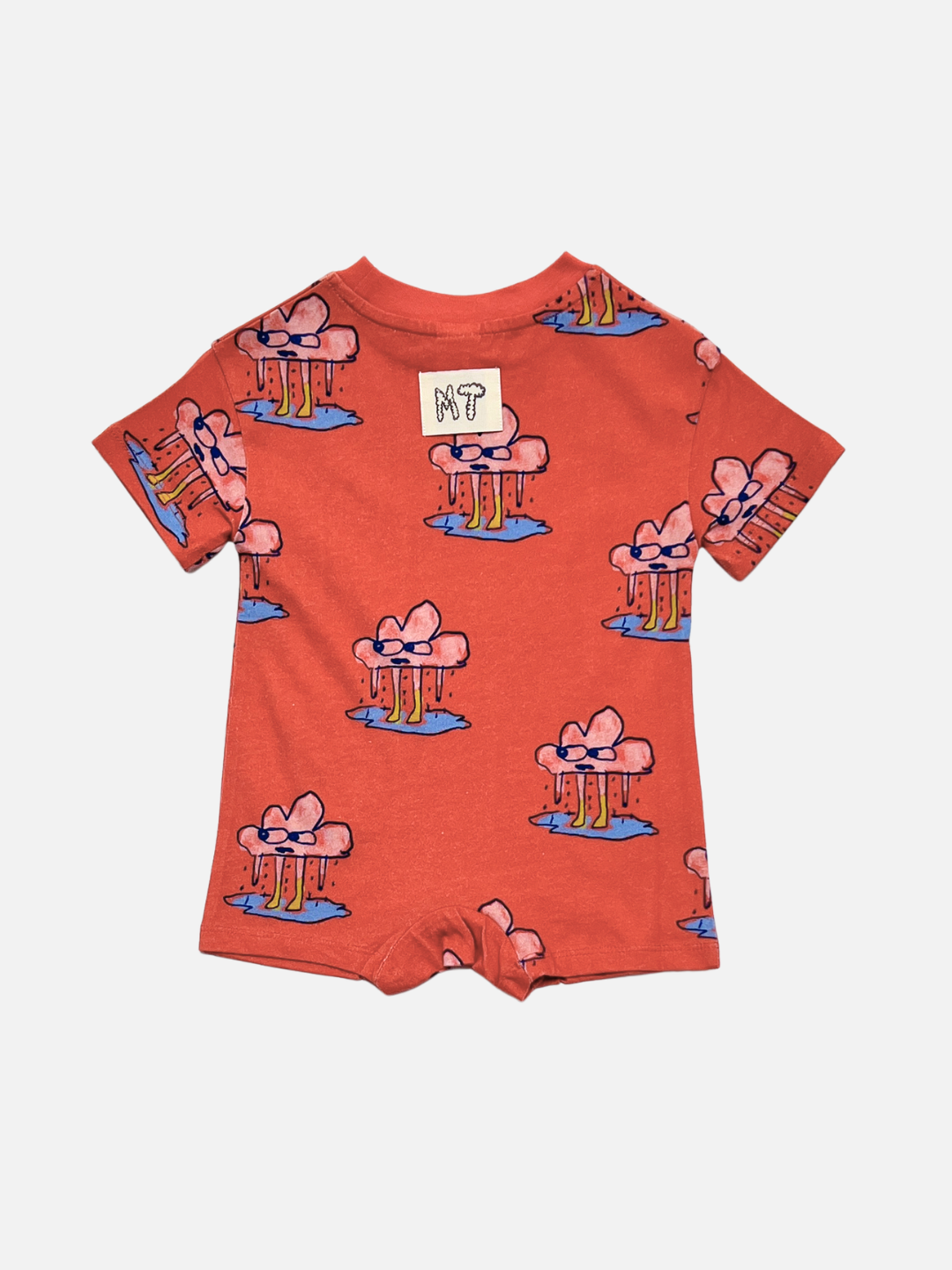 The RAINY DAY ROMPER is a red organic cotton romper with short sleeves, an all-over pink bow and blue shape print, and a white back patch featuring "MT?" in black.