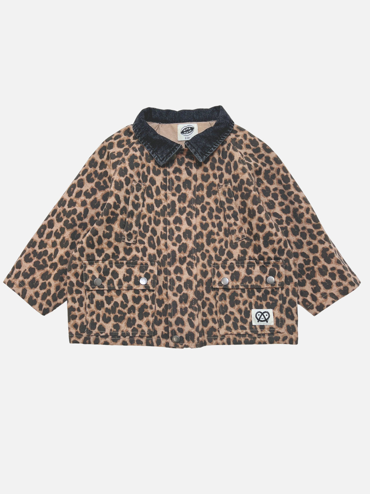 Leopard | A children's leopard-print jacket with a dark grey denim collar, laid flat on a light gray background. The jacket features a tan and brown base with black leopard spots, two front buttoned pockets, and a small white brand patch on the lower right pocket.
