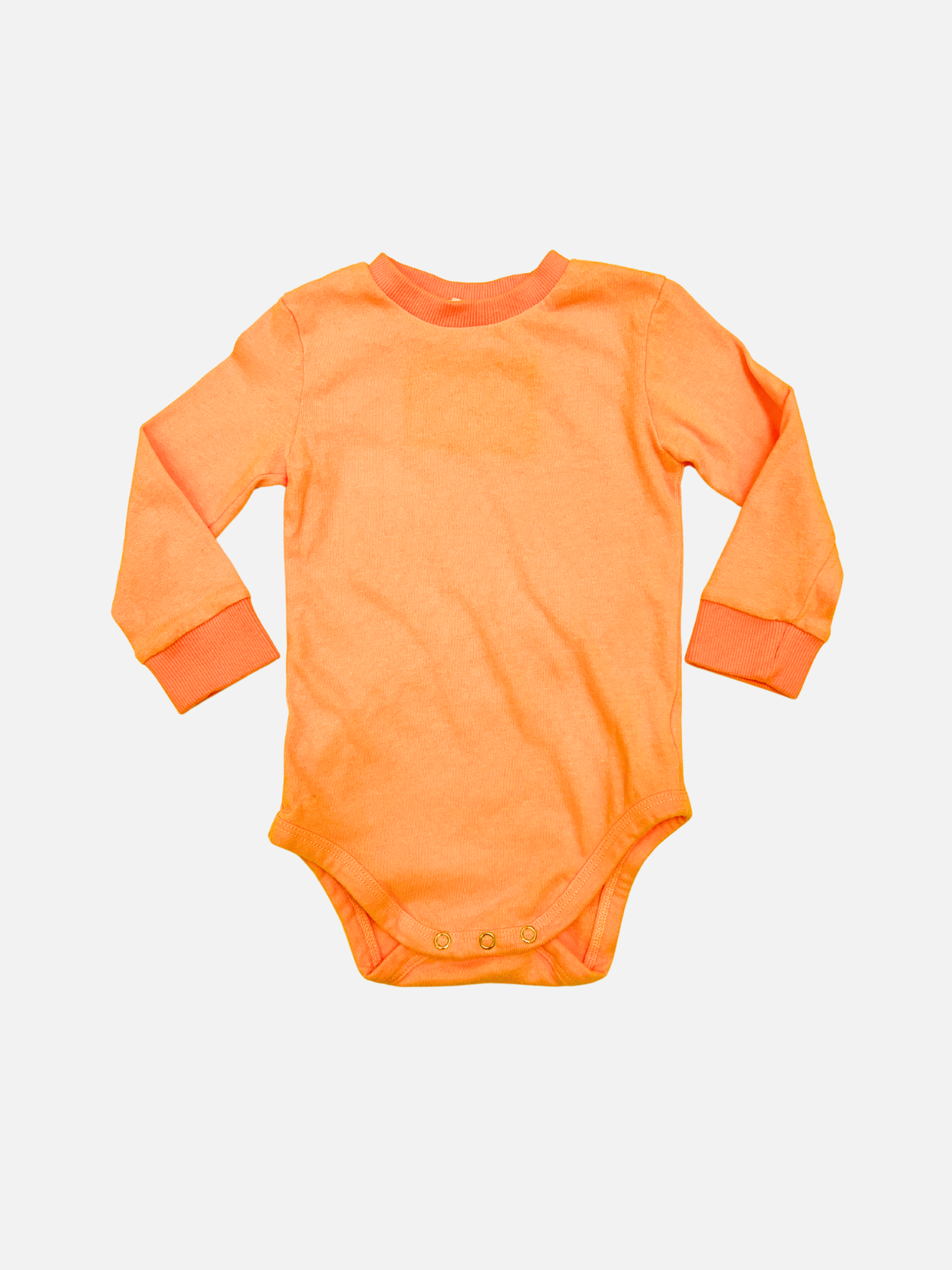 Orange | The PATCH ONESIE in orange is a soft cotton long-sleeve baby onesie with bottom snaps, shown laid flat on a white background.