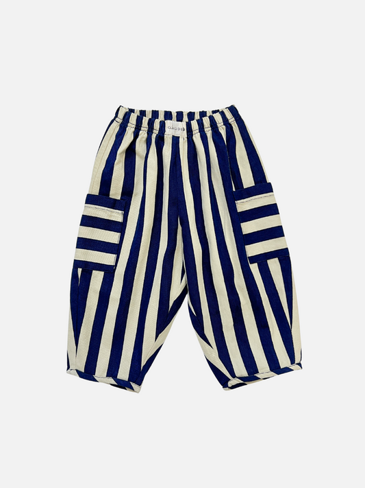 Image of The EMERSON MIDNIGHT STRIPE TROUSER features a loose fit, vertical blue and white stripes, an elastic waistband, and large side pockets with horizontal stripes. Displayed on a white background, it offers stylish comfort and excellent value.