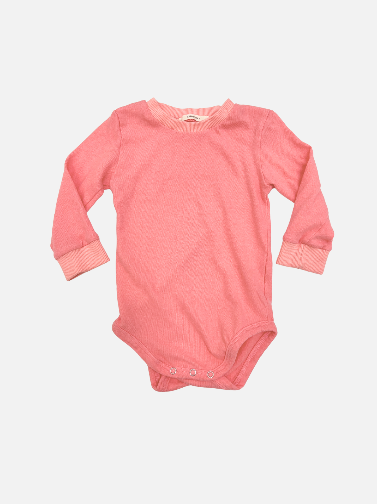 Pink | The PATCH ONESIE in pink is a soft cotton long sleeve onesie from a trusted Korean baby brand, featuring convenient snap buttons at the bottom and shown laid flat on a white background.